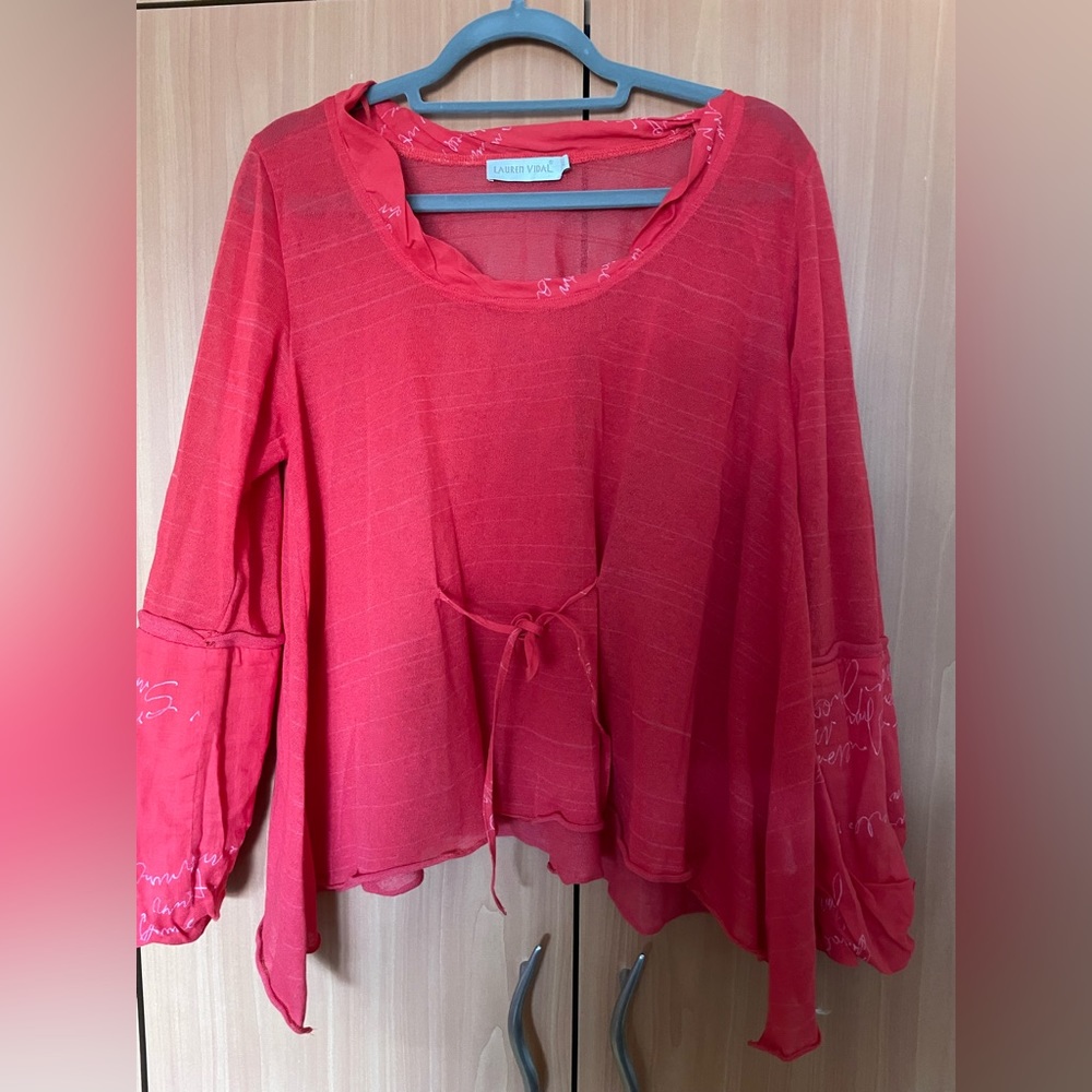 Oversized top. Goes well with pants or skirt. Very comfortable.